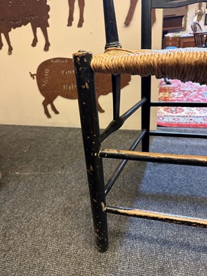 Lot 17 - An ebonised wooden elbow chair