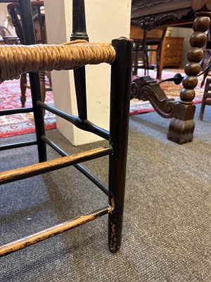 Lot 17 - An ebonised wooden elbow chair