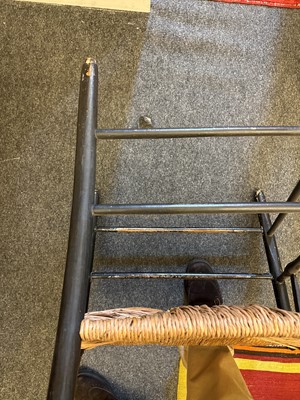 Lot 17 - An ebonised wooden elbow chair