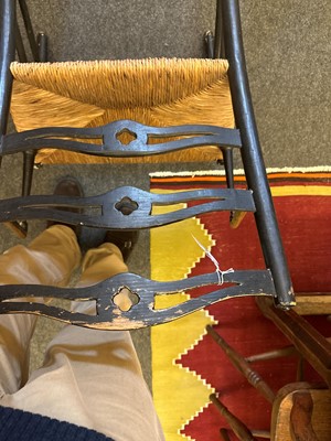 Lot 17 - An ebonised wooden elbow chair