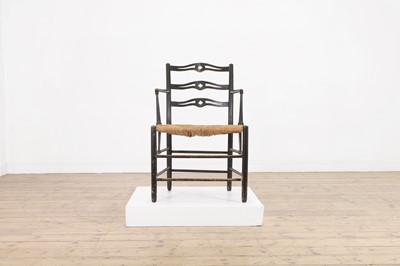 Lot 17 - An ebonised wooden elbow chair