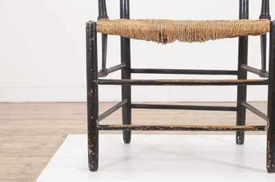 Lot 17 - An ebonised wooden elbow chair