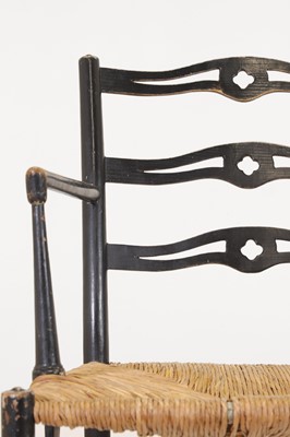 Lot 17 - An ebonised wooden elbow chair