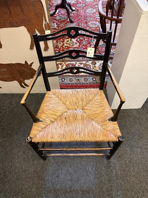 Lot 17 - An ebonised wooden elbow chair