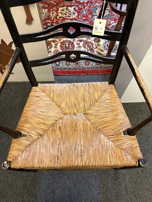 Lot 17 - An ebonised wooden elbow chair