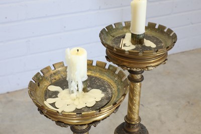 Lot 10 - A pair of tall brass candlesticks