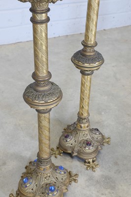 Lot 10 - A pair of tall brass candlesticks