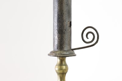Lot 360 - An iron and brass candlestick