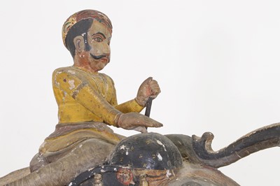 Lot 218 - A pair of Rajasthani carved and painted wooden elephants
