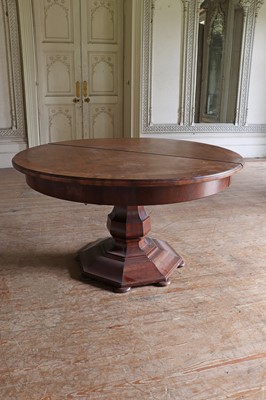 Lot 86 - A large circular walnut extending dining table