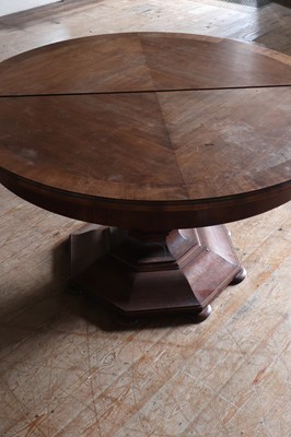 Lot 86 - A large circular walnut extending dining table