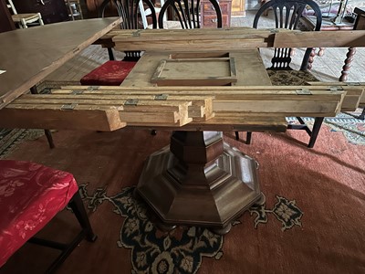 Lot 86 - A large circular walnut extending dining table