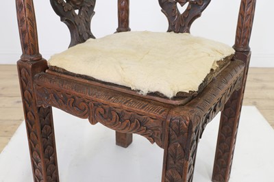 Lot 87 - A pair of George II-style carved walnut corner chairs