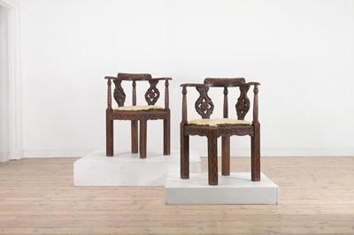 Lot 87 - A pair of George II-style carved walnut corner chairs