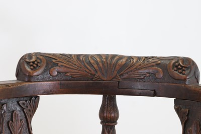 Lot 87 - A pair of George II-style carved walnut corner chairs