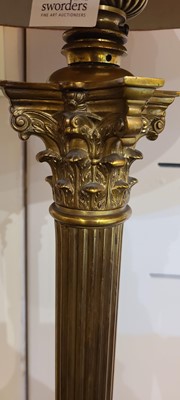 Lot 14 - A near pair of telescopic brass column floor lamps