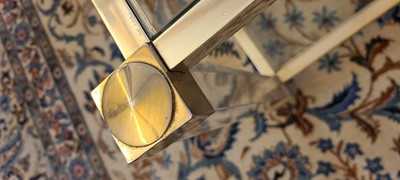 Lot 82 - A Lucite and brass coffee table