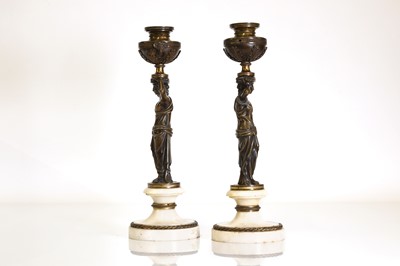 Lot 46 - A pair of Louis XVI patinated bronze and white marble candlesticks