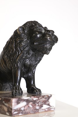 Lot 58 - A bronze model of a crouching lion