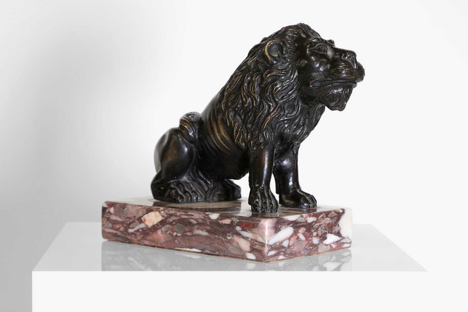 Lot 58 - A bronze model of a crouching lion
