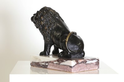 Lot 58 - A bronze model of a crouching lion