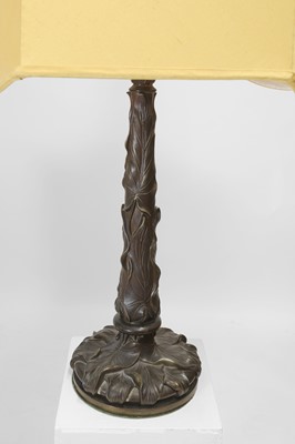Lot 69 - A pair of patinated bronze table lamps