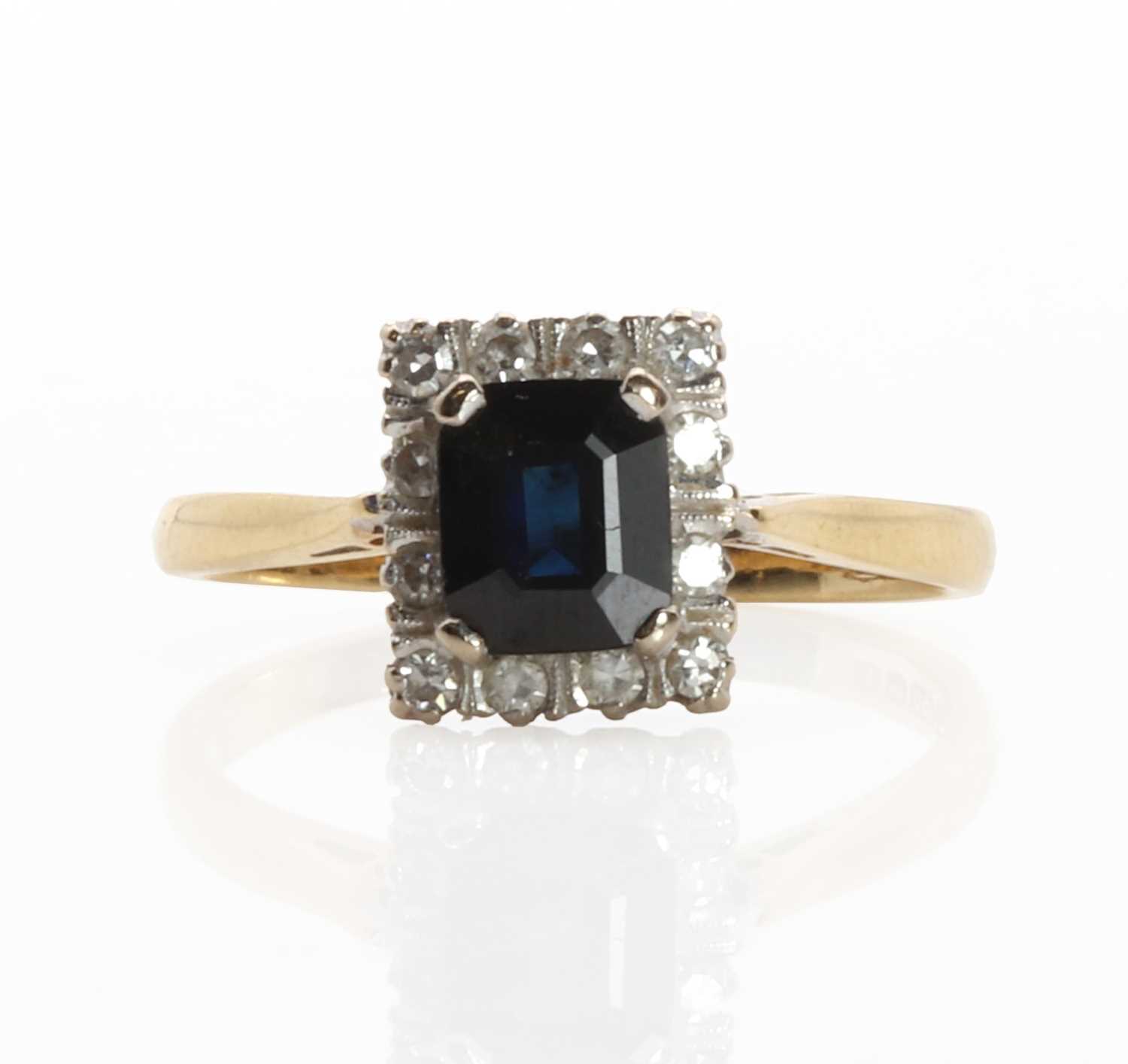 Lot 1155 - An 18ct gold sapphire and diamond cluster ring