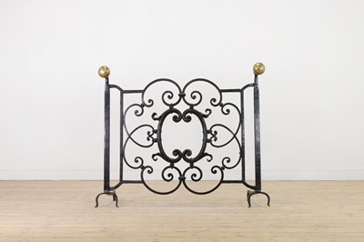 Lot 22 - A cast iron and brass fireguard