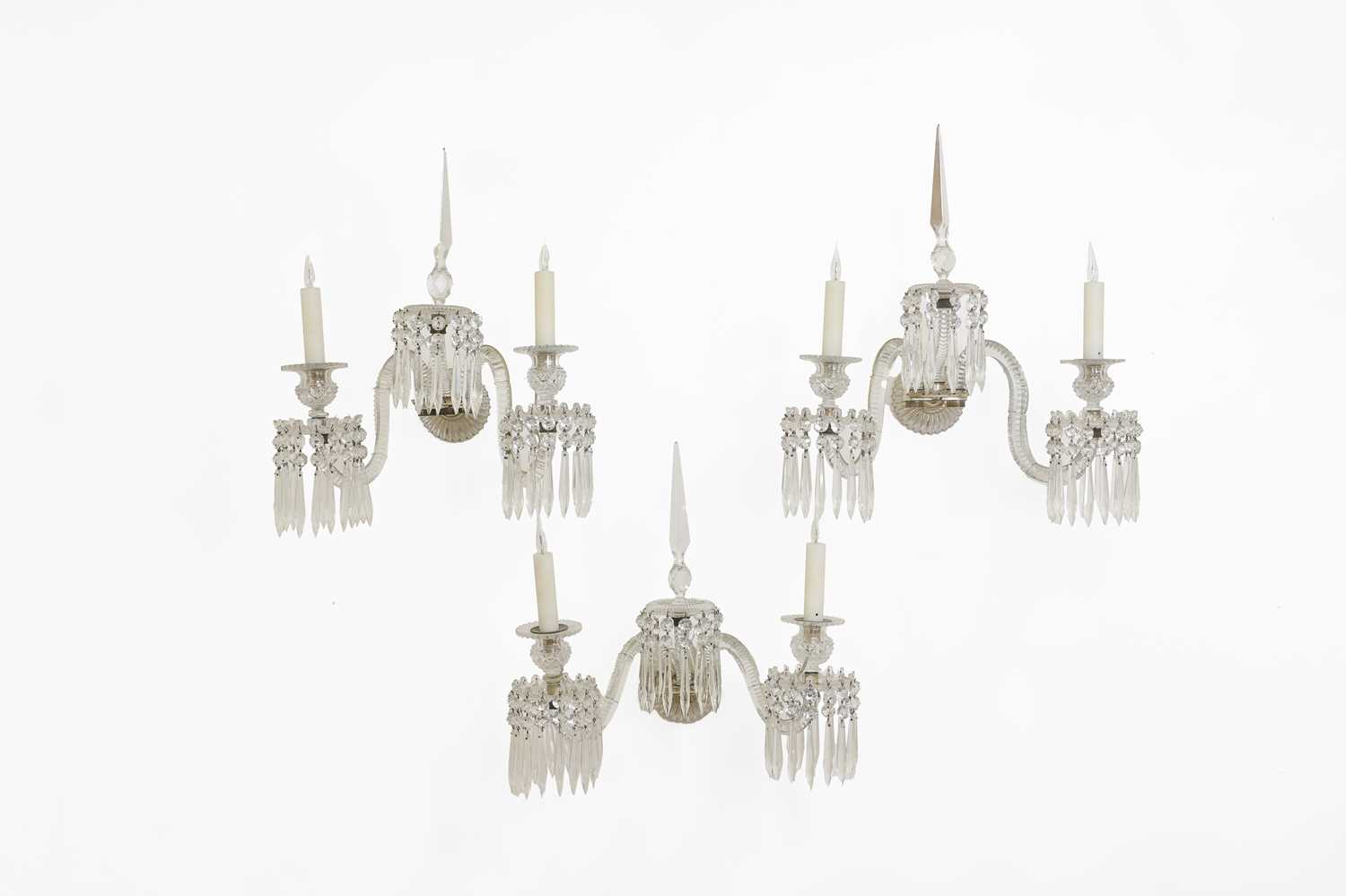 Lot 137 - A set of three cut-glass wall lights