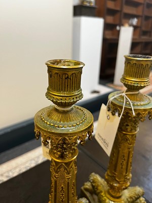 Lot 35 - A pair of George IV brass candlesticks