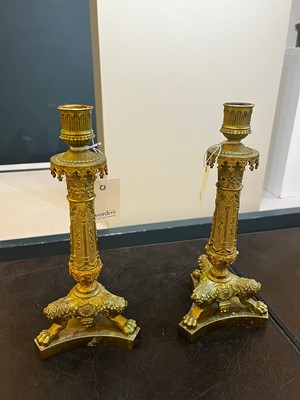 Lot 35 - A pair of George IV brass candlesticks