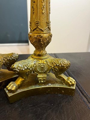 Lot 35 - A pair of George IV brass candlesticks