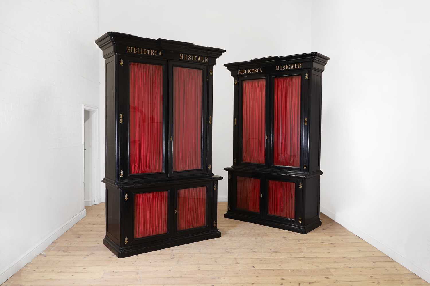Lot 202 - A pair of ebonised wooden library bookcases