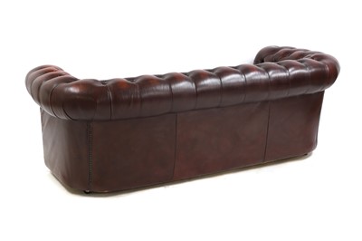 Lot 581 - A red leather Chesterfield sofa
