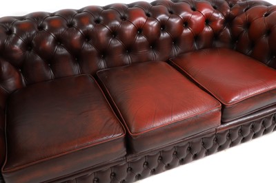 Lot 581 - A red leather Chesterfield sofa