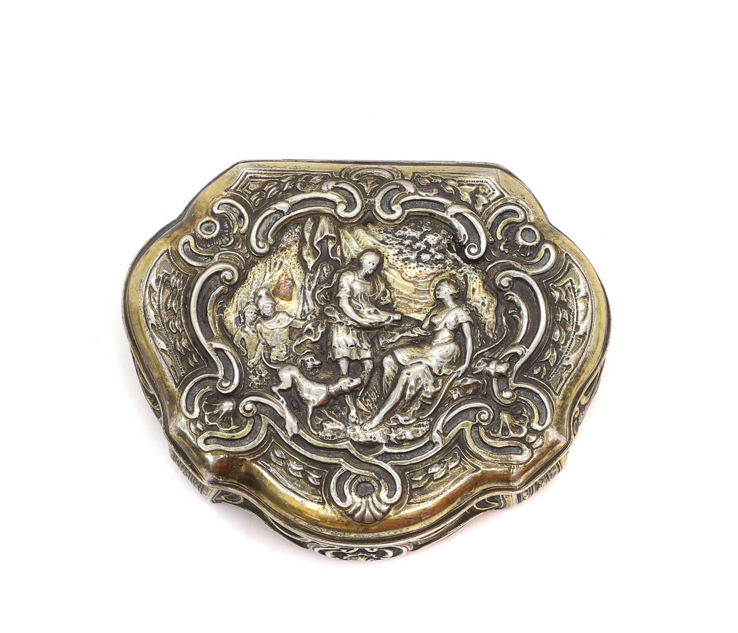 Lot 20 - A silver repousse cartouche shaped tobacco box