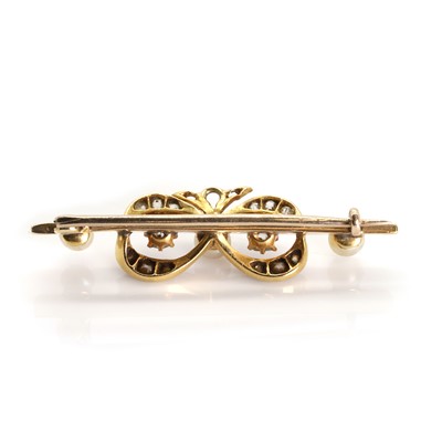 Lot 20 - A late Victorian pearl and diamond bow bar brooch, c.1890