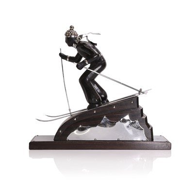 Lot 81 - An Art Deco-style carved wood and simulated coromandel skier centrepiece