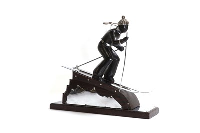 Lot 81 - An Art Deco-style carved wood and simulated coromandel skier centrepiece