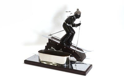 Lot 81 - An Art Deco-style carved wood and simulated coromandel skier centrepiece
