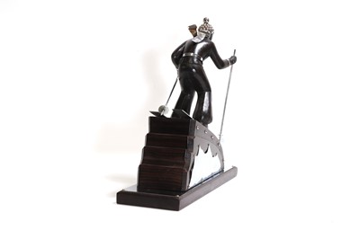 Lot 81 - An Art Deco-style carved wood and simulated coromandel skier centrepiece