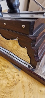 Lot 81 - An Art Deco-style carved wood and simulated coromandel skier centrepiece