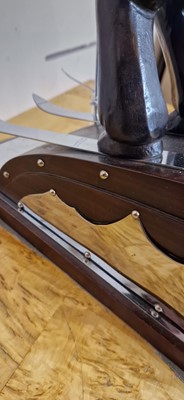 Lot 81 - An Art Deco-style carved wood and simulated coromandel skier centrepiece