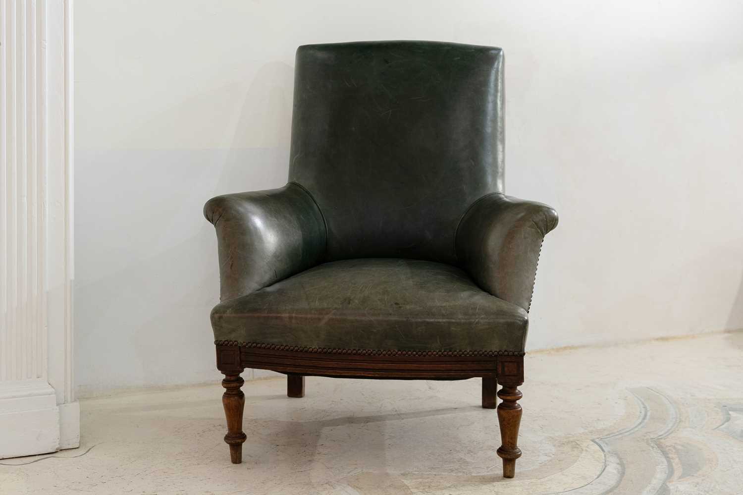 Lot 297 - A beech-framed green leather library chair