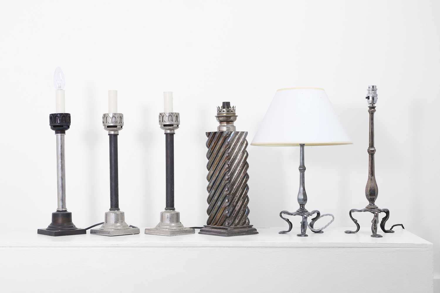 Lot 41 - A collection of silvered-metal oil and table lamps