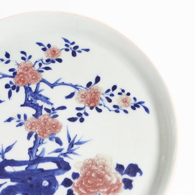 Lot 20 - A Chinese copper-red and underglaze blue plate