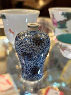 Lot 53 - A Chinese copper red and underglaze blue miniature vase