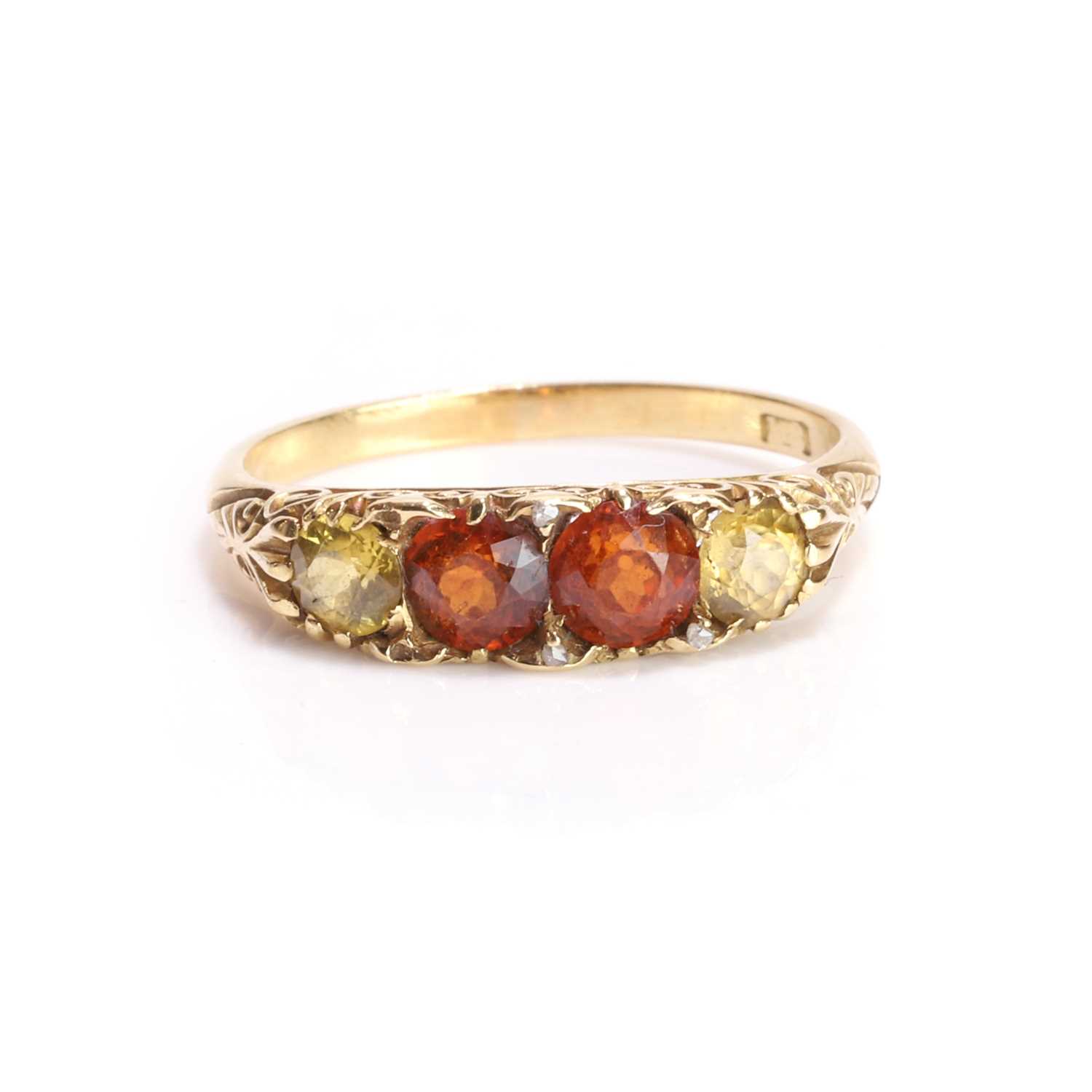 Lot 11 - A hessonite garnet and yellow gemstone carved head ring