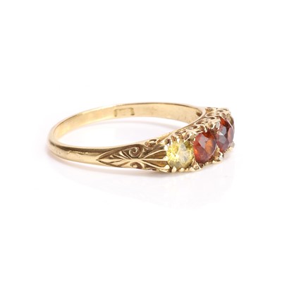 Lot 11 - A hessonite garnet and yellow gemstone carved head ring