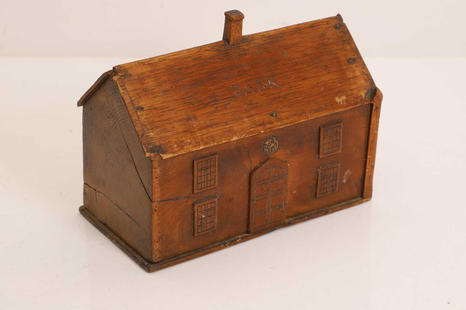 Lot 327 - A folk art elm money box